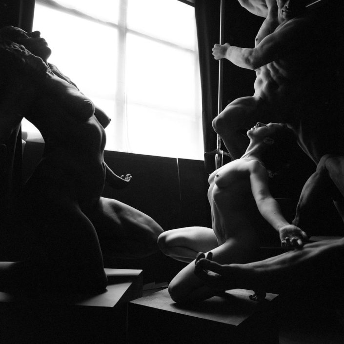 A group of people sitting in front of a window.