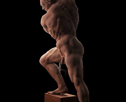 A muscular man standing on top of a box.