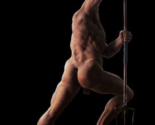 A naked man is standing on a pole