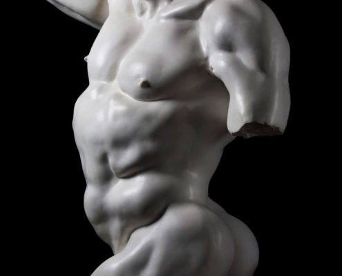 A white statue of a man with no shirt.