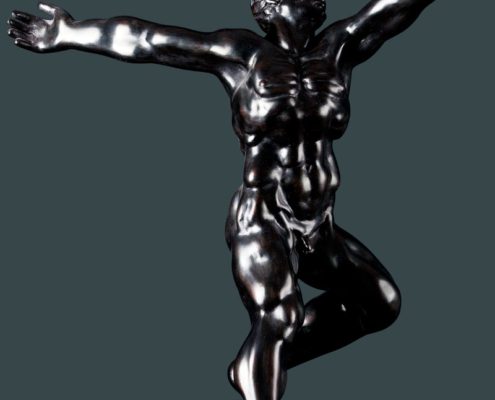 A silver statue of a man with arms outstretched.