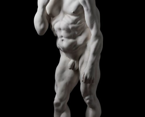 A white statue of a man with no shirt.