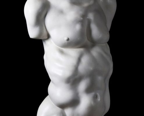 A white statue of a man with no shirt.