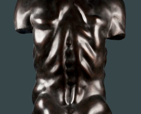 A bronze statue of a man 's torso with no shirt.