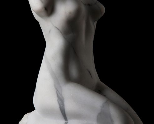 A white statue of a woman with a black background