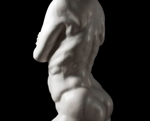 A white statue of a man with no shirt.