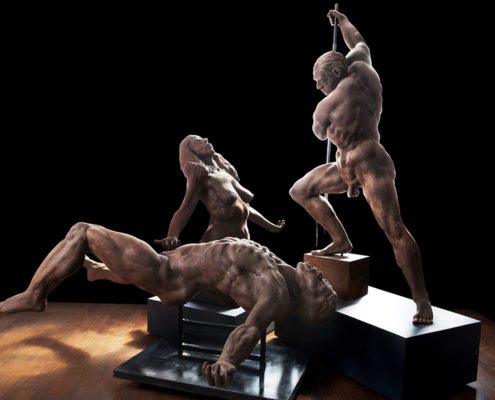 A group of three statues that are on top of a table.