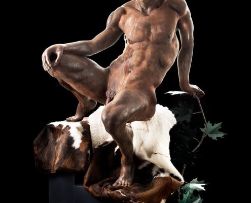 A statue of a naked man and dog.