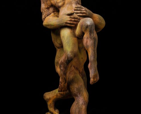 A sculpture of two people embracing each other.