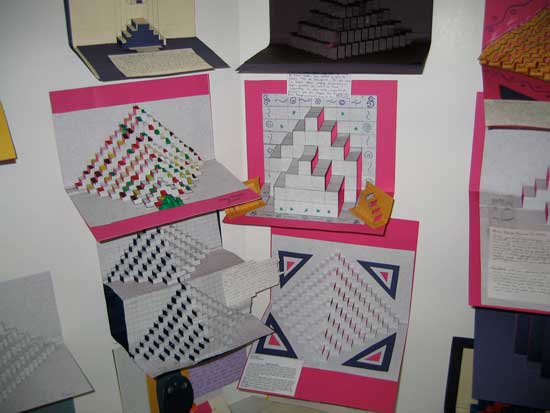 A display of different types of paper folded into squares.