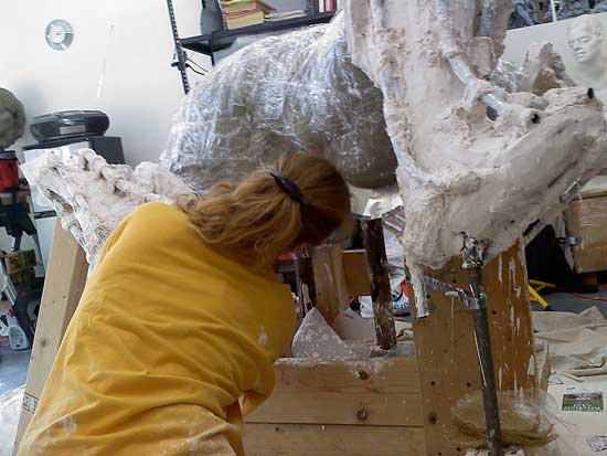 A woman in yellow shirt standing on the floor.