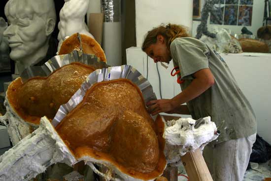 A woman is cooking food in the kitchen.