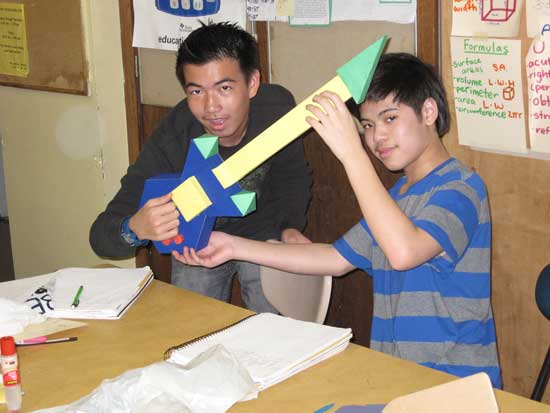 A man and boy are playing with some shapes.