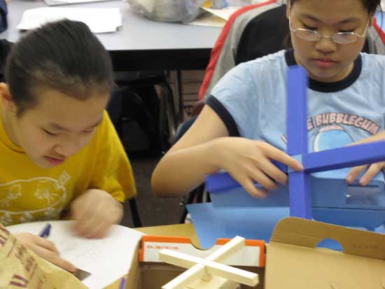 Two children are working on a project together.