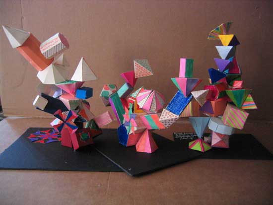 A group of colorful paper sculptures on top of black papers.