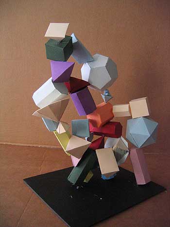 A sculpture of various colored blocks on top of a black base.