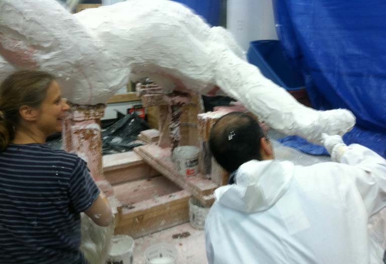 A group of people working on some type of sculpture.