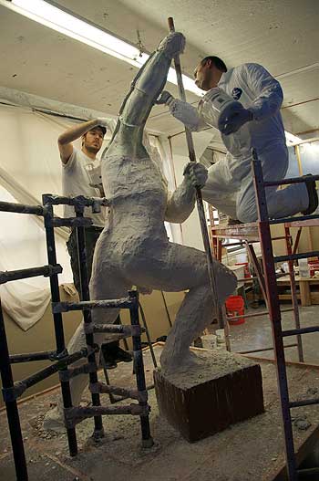 A man is standing on some steps and wearing white