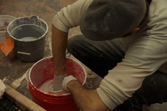 A man is making something out of clay.